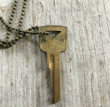 Back side of Vintage Gold Tone Hand Stamped Key LIVE FREE on ball chain