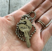 Hand Stamped Upcycled Key Necklace WILD CHILD with vintage ball chain shown in hand for scale