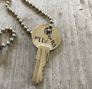 close up of Hand Stamped recycled Key Necklace WILD CHILD with vintage ball chain