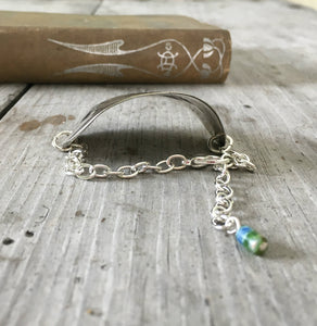 View of curve on stamped spoon bracelet about creativity