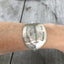 Hand stamped spoon bracelet about creativity shown on model's arm