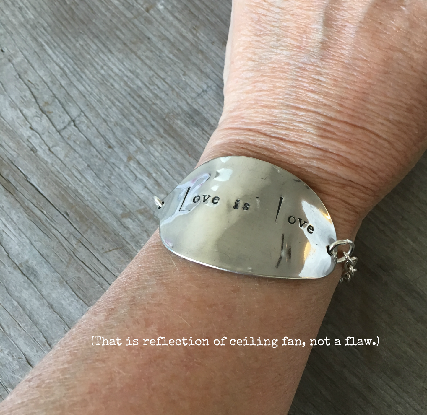Stamped Spoon Bracelet Love is Love shown on models arm