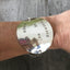 Upcycled silverware teacher appreciation bracelet worn on wrist, showing adjustable chain 