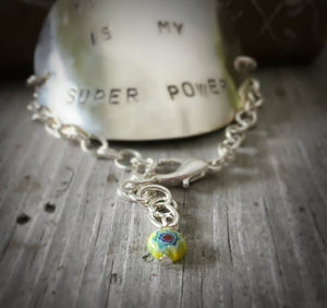 Close up of bead on teaching is my super power bracelet