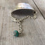 Hand-stamped vintage spoon bracelet with 'Wanderlust & City Dust' message and turquoise glass bead accent