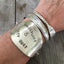 upcycled silverware bracelet with wanderlust message worn on wrist for size and scale
