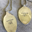 Close up of Stamped Spoon Necklaces Wander with Airstream Trailer