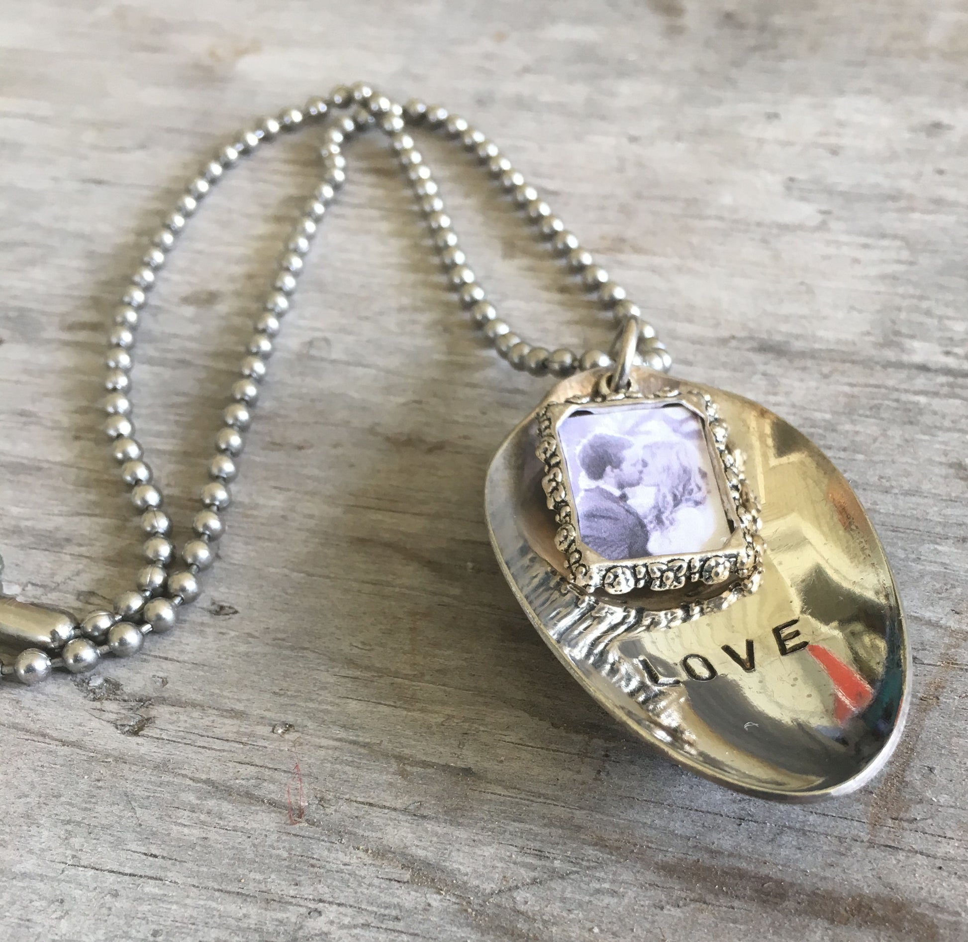Side view of LOVE spoon necklace showing vintage silverware bowl and pewter photo frame detail, one-of-a-kind handcrafted design