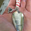 Stamped Spoon Christmas Ornament shown in hand for scale