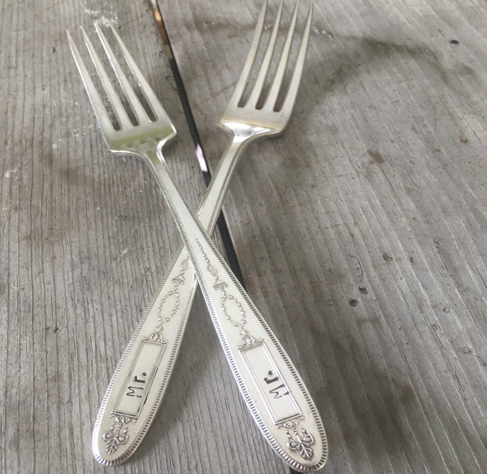 Pair of handstamped vintage silverplate forks for cake table at gay wedding 