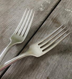 The vintage silverplate wedding cake forks have long tines