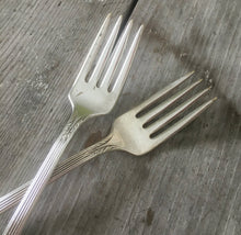 Close up of the short tines on these grille forks stamped for wedding cake table