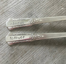Closeup of the stamped handles on the Treasure Always and Forever Wedding Cake Forks