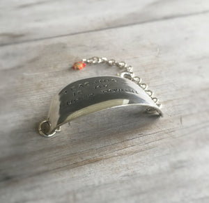 Stamped spoon bracelet with Teaching is my super power showing curve of bracelet