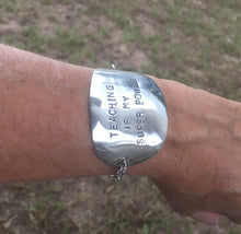 Stamped spoon bracelet with Teaching is my super power shown on wrist