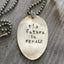 Close-up of THE FUTURE IS FEMALE hand-stamped spoon pendant showing bold message on reclaimed vintage silverware, empowering design