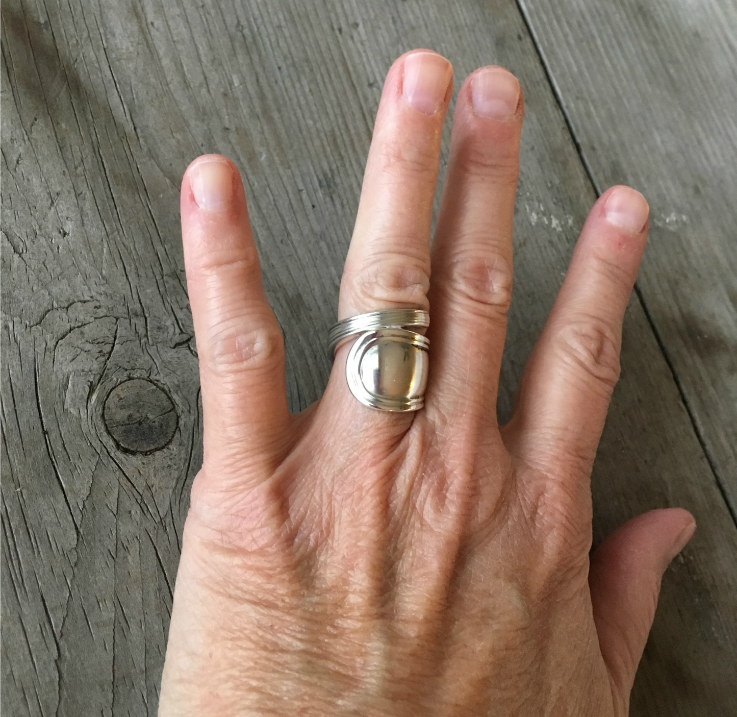 Sterling silver spoon ring in coil wrap design shown on model's hand
