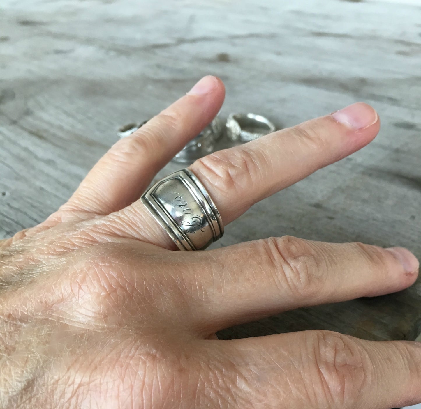 Lois sterling silver spoon ring shown on hand - handcrafted upcycled vintage silverware jewelry