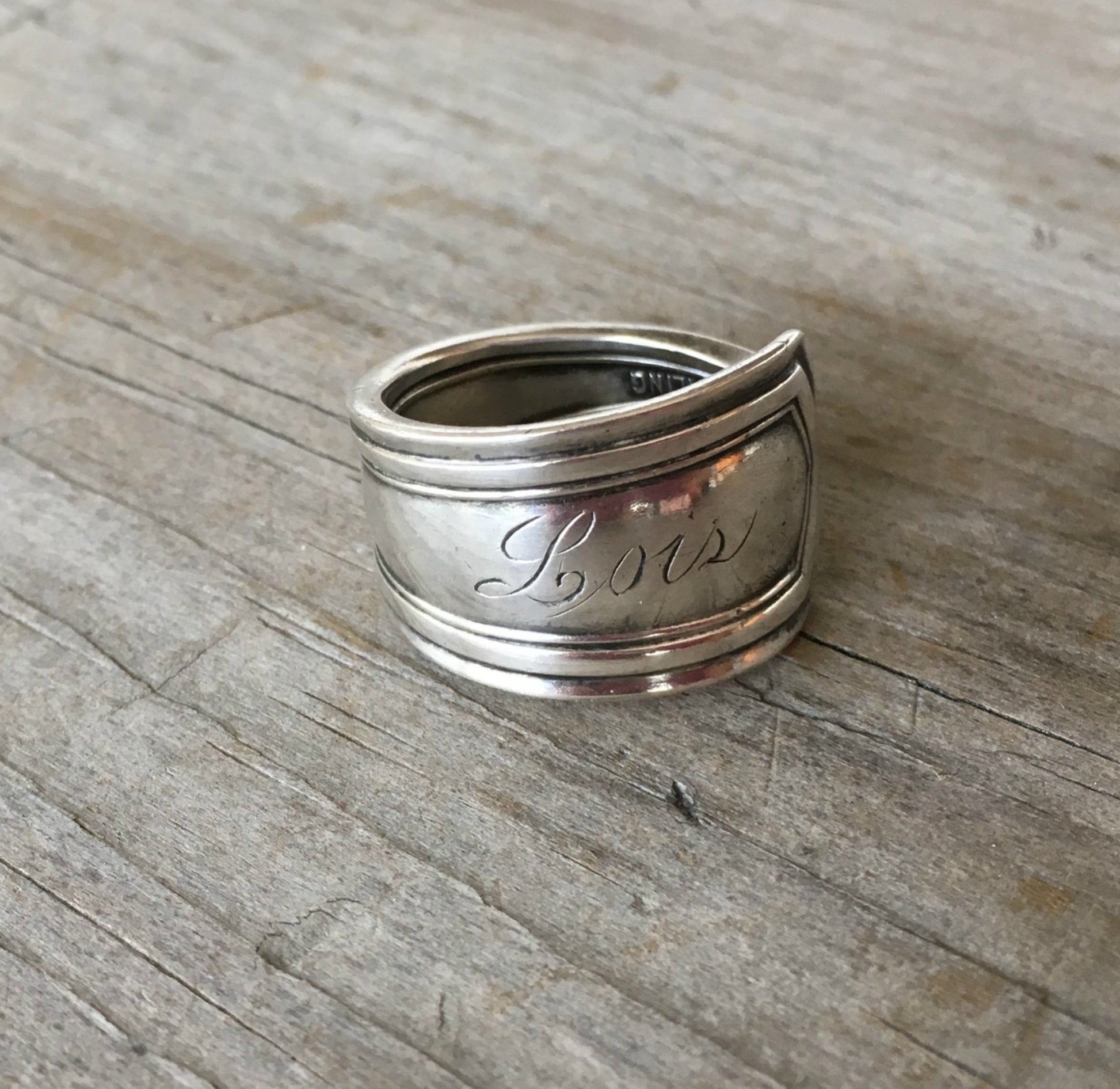 Close-up of original Lois monogram on sterling silver upcycled vintage fork ring