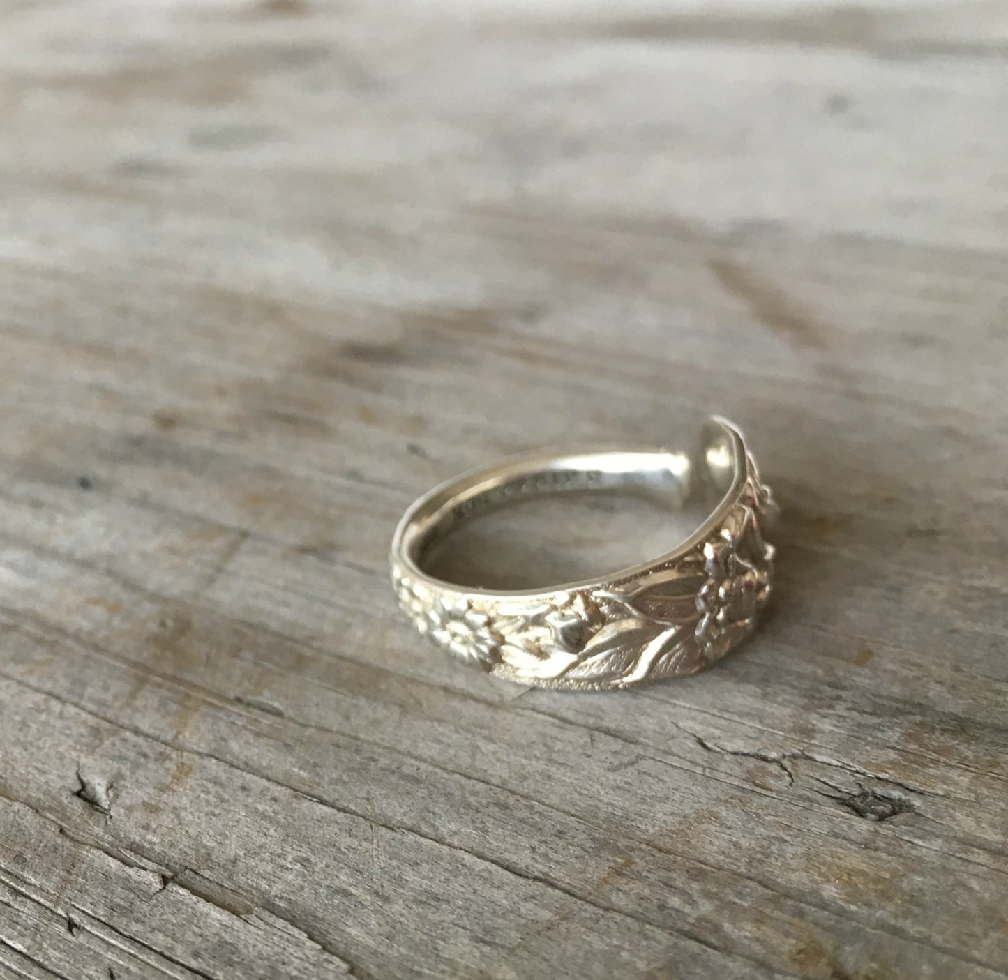 Detail of deeply embossed floral repoussé technique on antique Kirk & Son sterling silver spoon ring