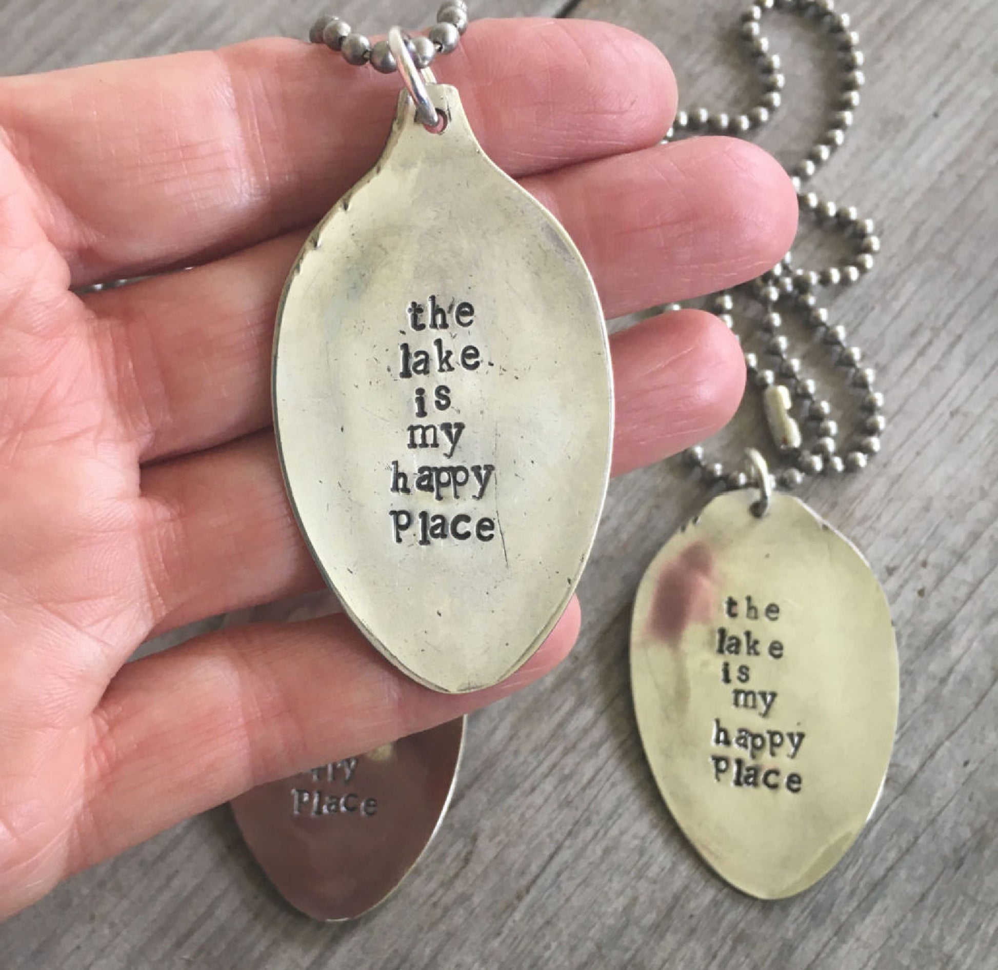 THE LAKE IS MY HAPPY PLACE spoon necklace held in hand for scale one-of-a-kind gift for lake friend
