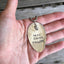 Stamped Spoon Necklace with Owl Charm Reads Here Comes Trouble Shown in Hand for Scale