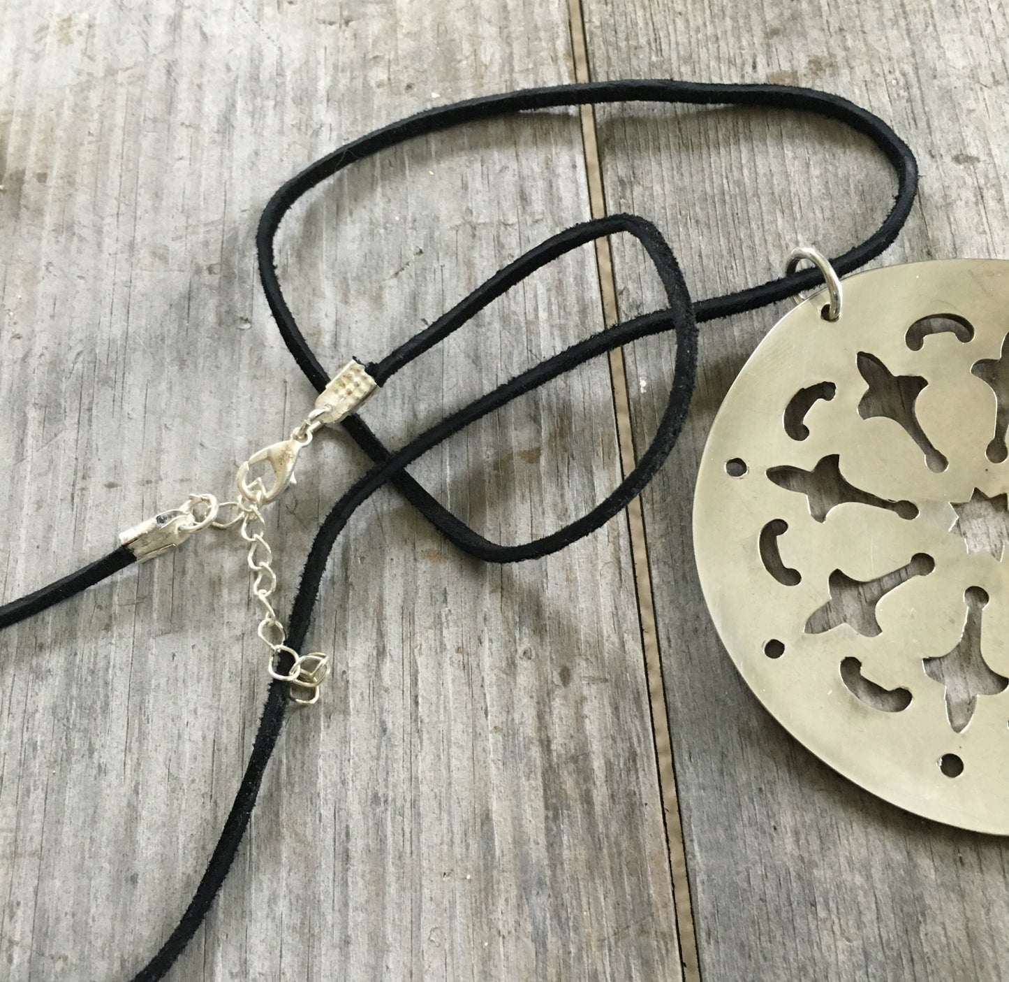 Closeup of cord and clasp on tomato server necklace