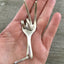 Fork Peace Key ring shown in hand for size and scale
