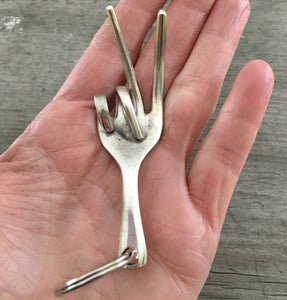 Fork Peace Key ring shown in hand for size and scale