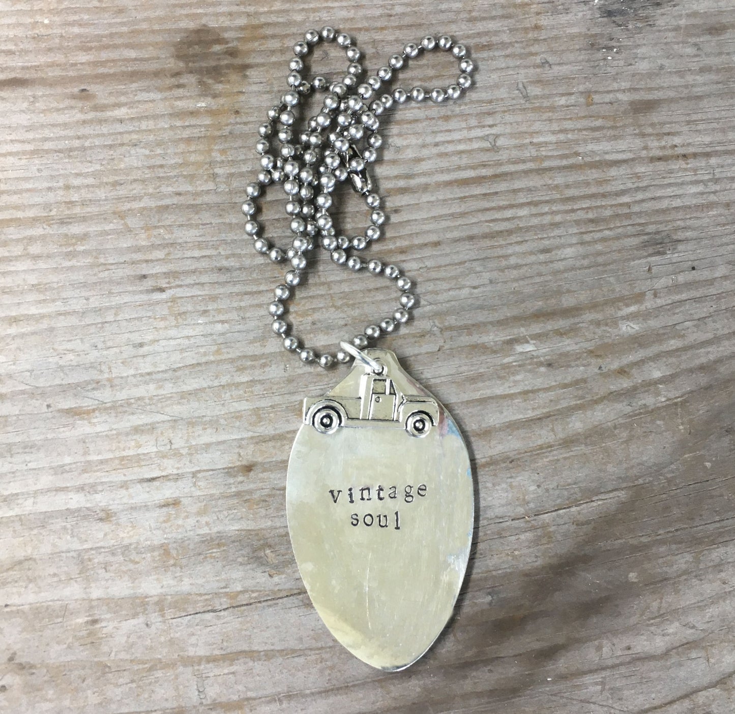 Close-up of VINTAGE SOUL stamped spoon necklace with vintage truck charm on ball chain, one-of-a-kind upcycled silverplate