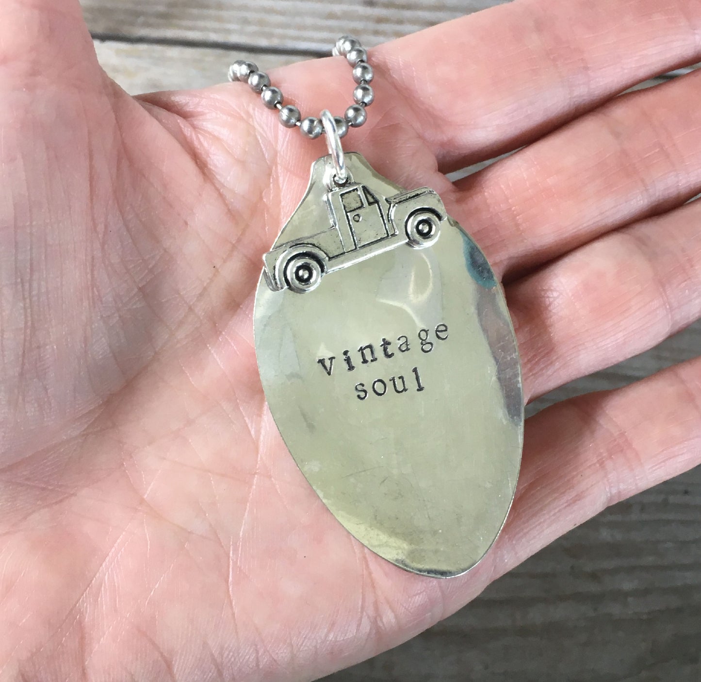 VINTAGE SOUL hand-stamped spoon necklace with vintage truck charm held in hand for scale unique vintage font