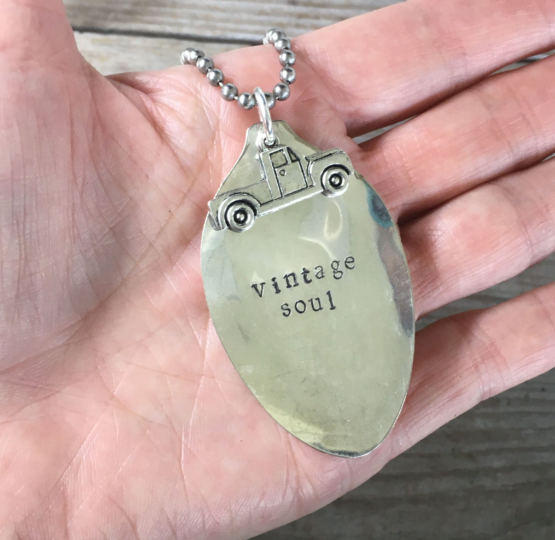 VINTAGE SOUL hand-stamped spoon necklace with vintage truck charm held in hand for scale unique vintage font