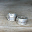 Close-up of WANDER pattern spoon rings showing vintage silverware detail and stamping