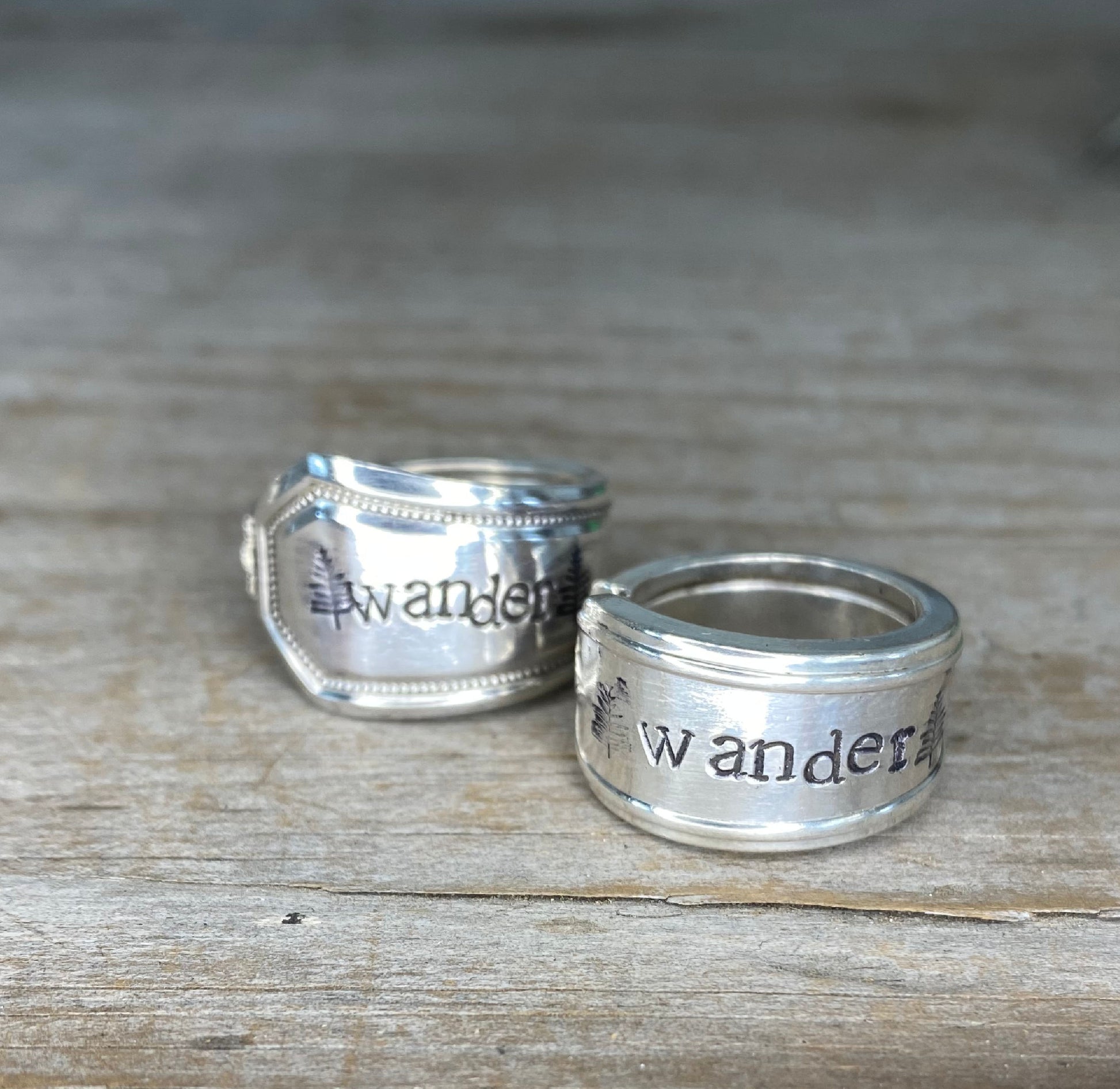 Close-up of WANDER pattern spoon rings showing vintage silverware detail and stamping