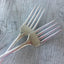 Tines of Handstamped mismatched set wedding cake forks