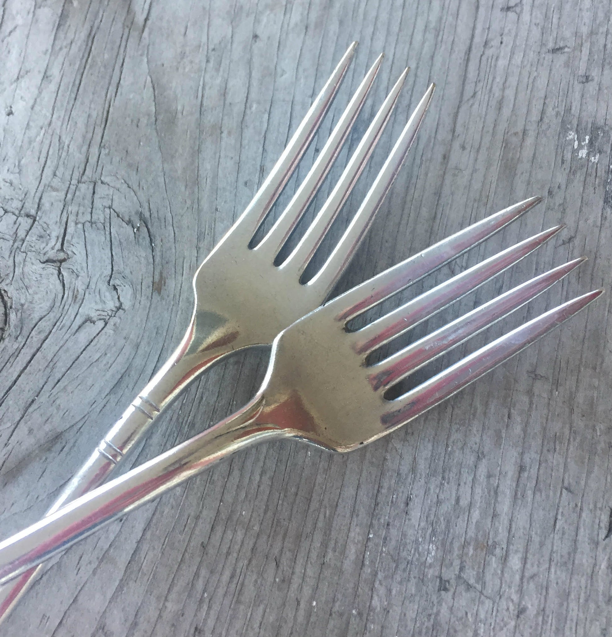 Tines of Handstamped mismatched set wedding cake forks