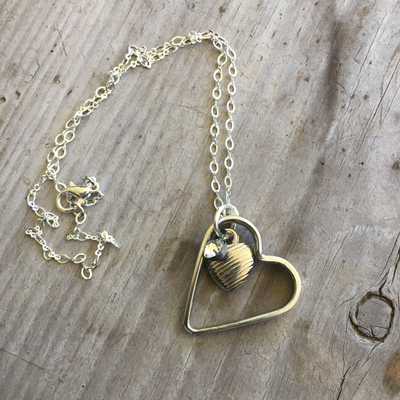 Fork tine floating heart necklace made from upcycled vintage silverware