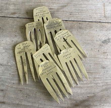 Pile of upcycled fork bookmarks handstamped with fun phrases