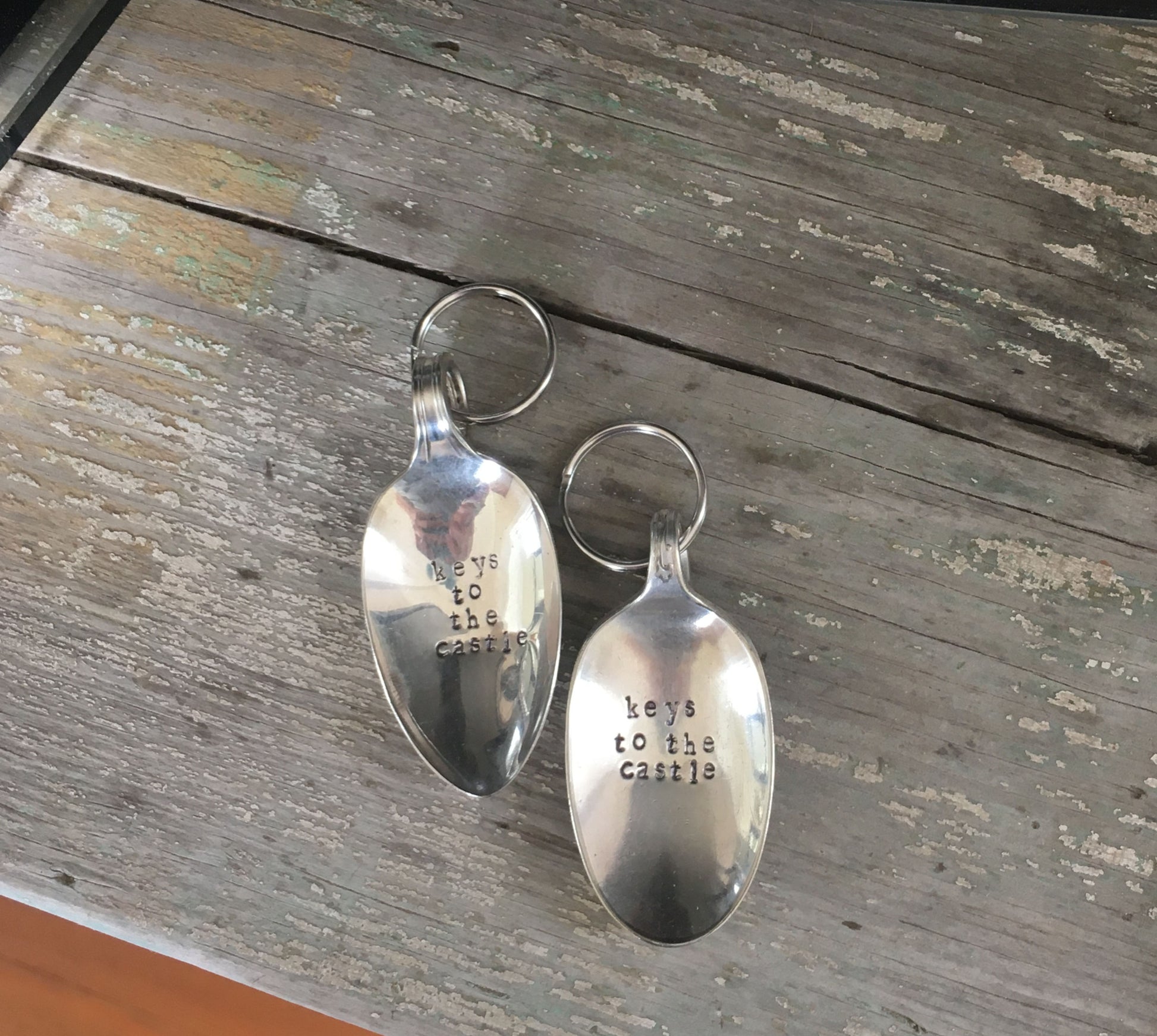 Close-up of Keys To The Castle hand-stamped lettering on vintage spoon keychain upcycled silverware