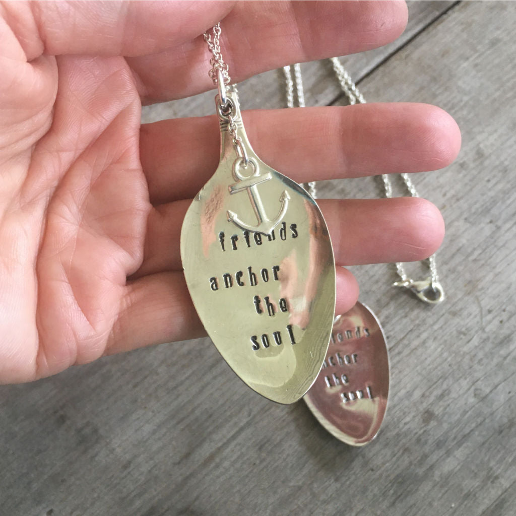 Close-up of FRIENDS ANCHOR THE SOUL hand-stamped spoon pendant with pewter anchor charm showing reclaimed vintage silverware, sentimental design