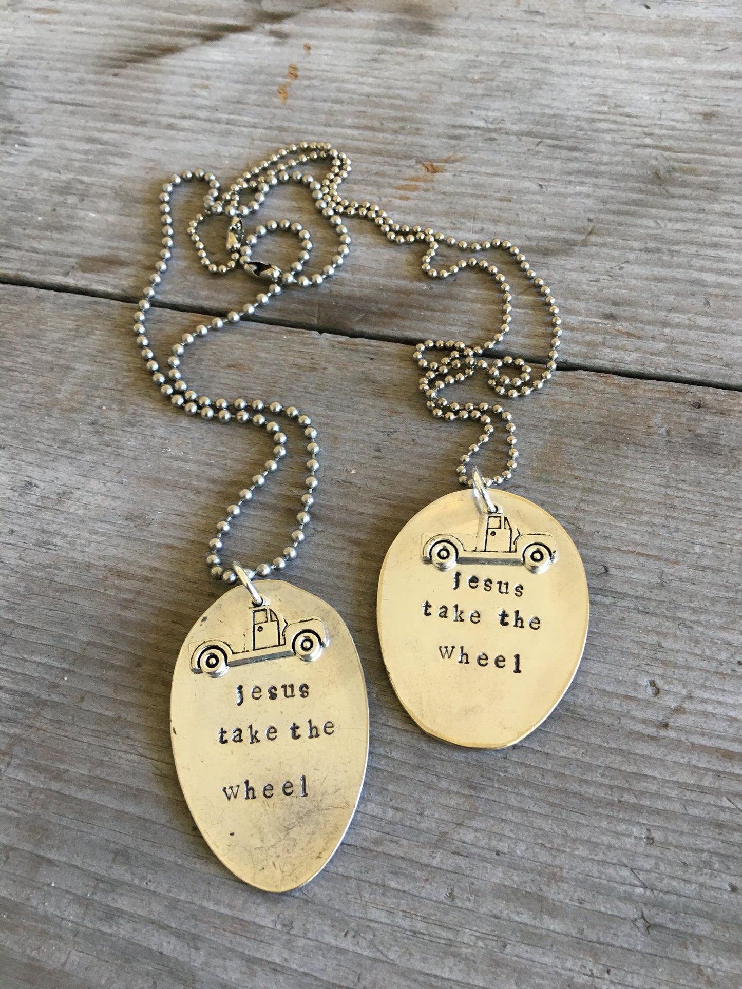 Multiple JESUS TAKE THE WHEEL stamped spoon necklaces with vintage truck charms showing one-of-a-kind handcrafted designs
