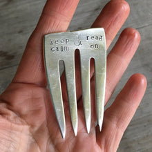 Upcycled Fork Bookmark shown in hand for scale