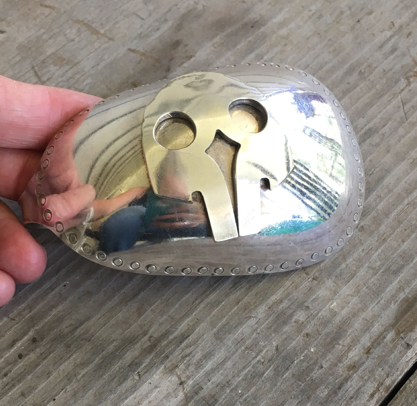 Close up of workmanship on upcycled Spoon belt buckle with applied fork skull detail