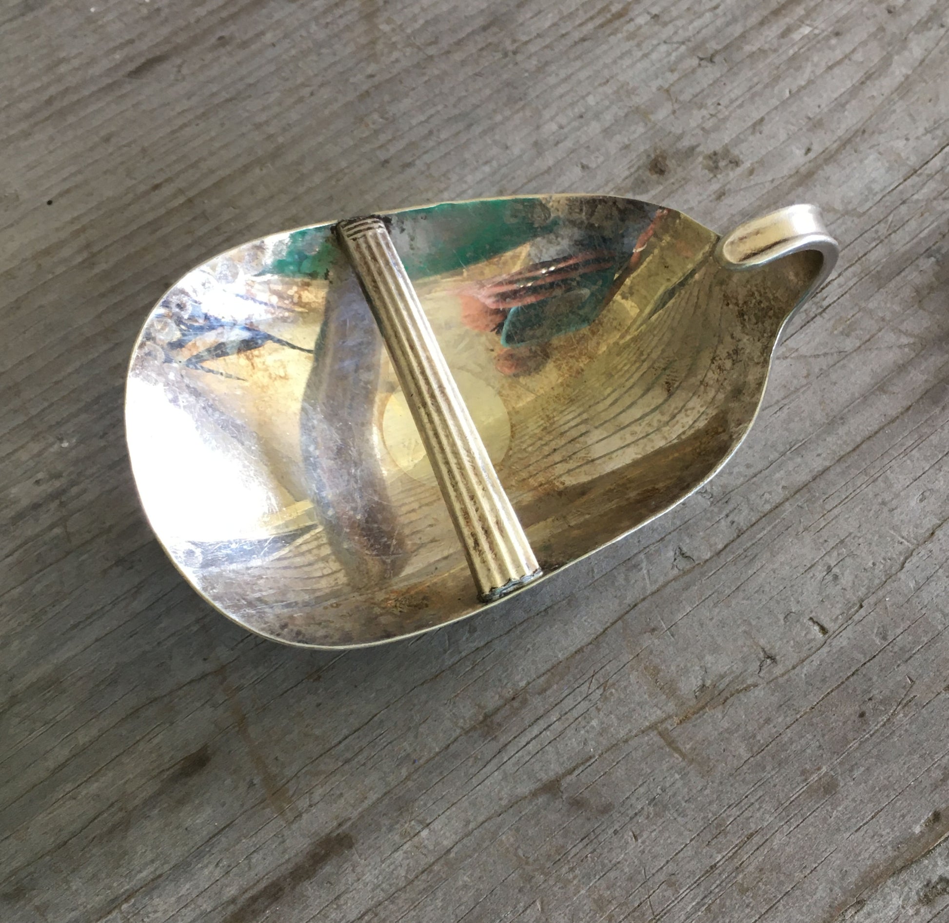 back side of upcycled Spoon belt buckle with applied fork skull detail