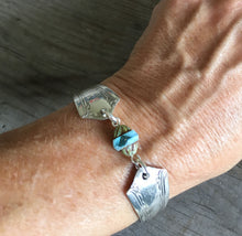 Upcycled silverware bracelet shown on model