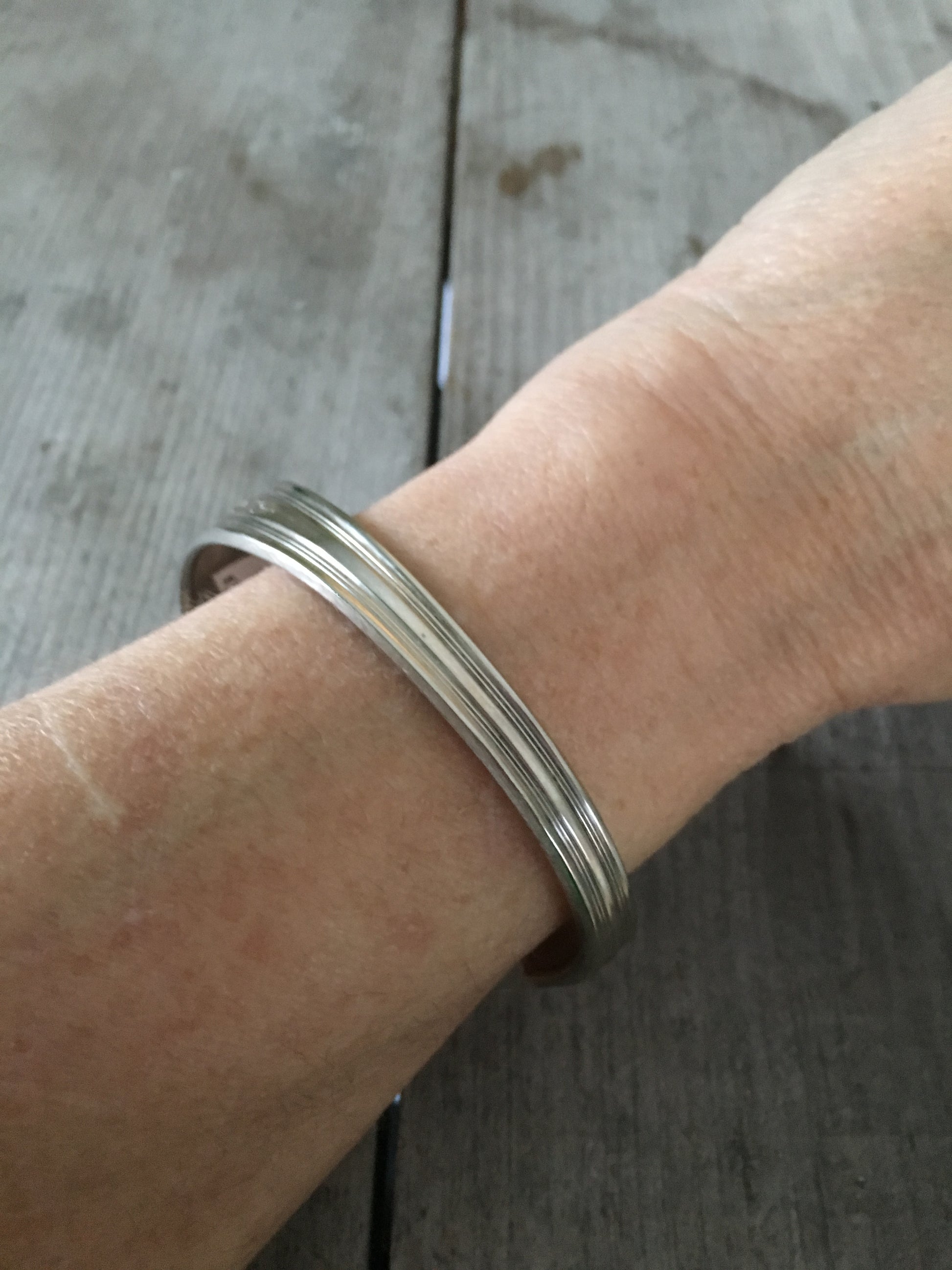 Peace Spoon Cuff bracelet shown on model's arm